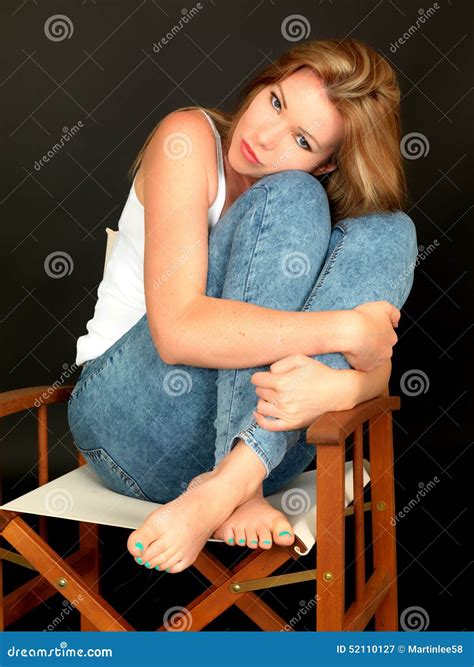 Beautiful Young Woman Sitting In A Chair Thoughtfully Stock Image