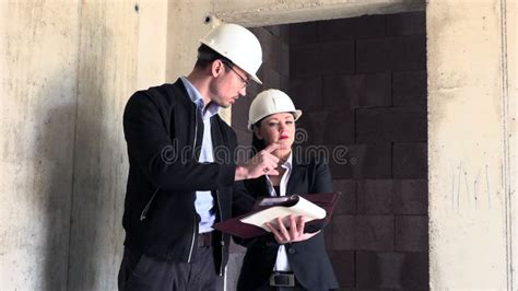 Two Architects A Man And A Woman In Construction In White Helmets Stock Footage Video Of