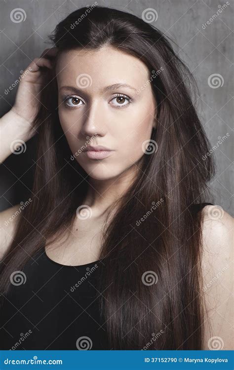 Portrait Of Young Beautiful Woman With Straight Brown Hair Stock Photo