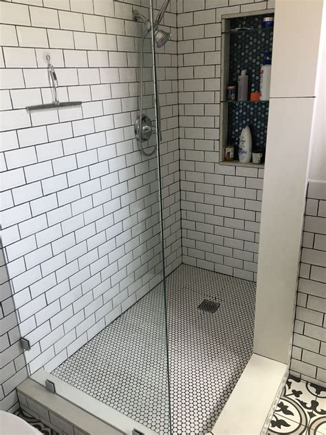 Installing the curb for a tile shower. Open shower with penny tile & subway tile. Visual interest ...