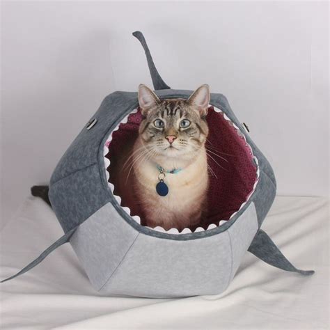 A Cat Sitting In A Shark Shaped Bed