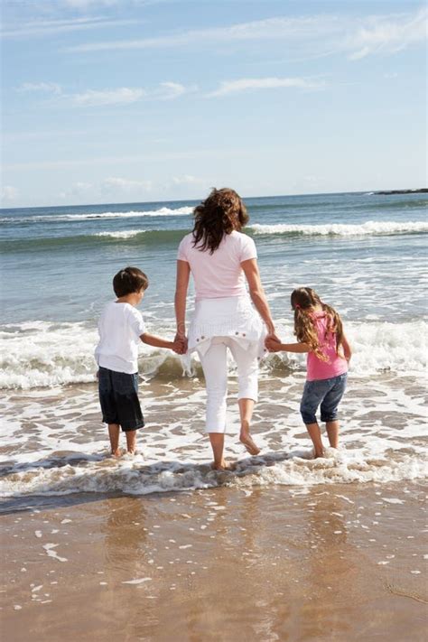 Mother And Children Having Fun On Beach Holiday Stock Image Image Of