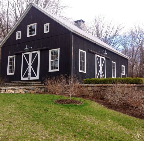 Pole barn/post frame building trims. Black barn white trim with field rock fence. | Black barn ...