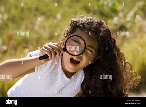 Portrait Of Happy School Girl Bending Over White Background Stock Photo