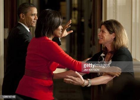 Us President Barack Obama Waves As First Lady Michelle Obama Hugs