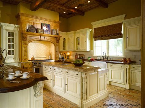 Brown kitchen cabinets adorned with aged brass pulls are fixed under brown pulls flanked by cabinets finished with brass grille fronts. Clive Christian Kitchen in Antique French Oak & Cream ...