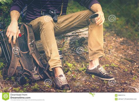 Traveler Man Relaxing In Forest With Photo Camera Backpack And Thermos