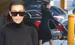 Kim Kardashian Shows Off Famous Derriere In Clingy Dress