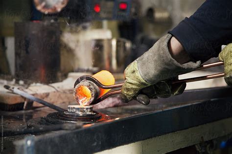 Hands Of Crafter Pouring Metal By Stocksy Contributor Danil Nevsky Stocksy