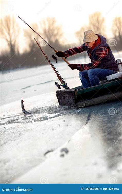 Fisherman Catch Fish Ice Fishing On Frozen Lake Stock Image Image