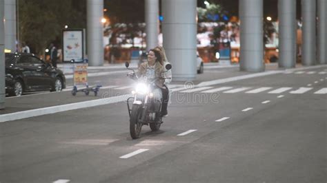 Beautiful Young Woman Motorcyclist With His Girlfriend Riding A Motorcycle In A Night City On A