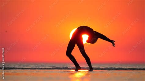 In Breathtaking Sunset Setting Graceful Gymnast Girl Bends Backward Her Slender Silhouette