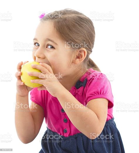 Little Girl Eating Apple Isolated On White Background Stock Photo