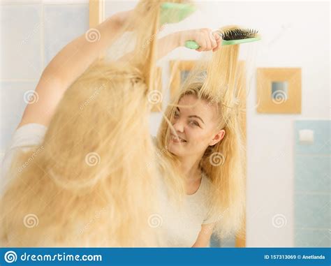 Woman Brushing Her Blonde Hair In Bathroom Stock Image Image Of