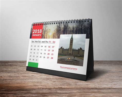 A Desk Calendar With An Image Of A Clock Tower In The Background On A