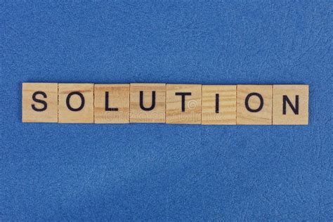 Word Solution On Scrabble Wooden Letters On A Rack Stock Photo