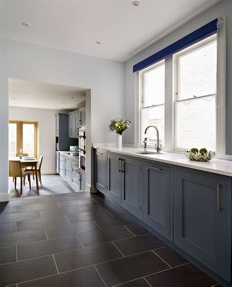 This digital photography of kitchen with slate floor tile has dimension 1080 x 1080 pixels. Hand-painted, dark blue cabinets have been paired with ...