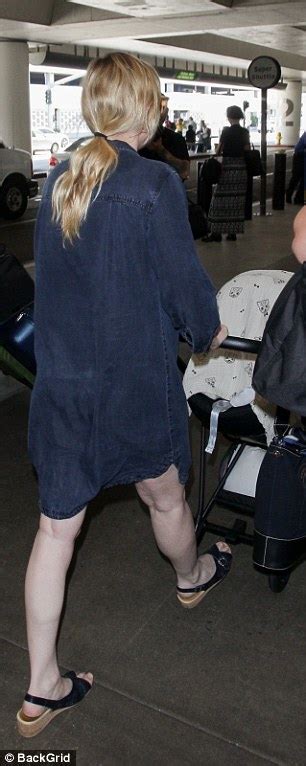 Kirsten Dunst Flashes Lithe Legs In Oversize Denim Shirtdress At Lax
