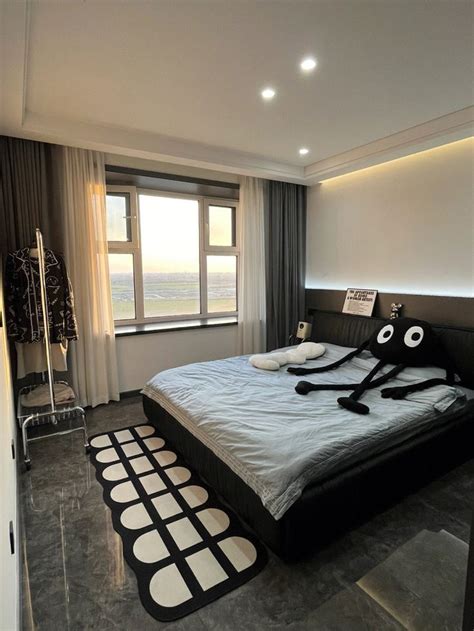 A Large Bed In A Room With Black And White Decor