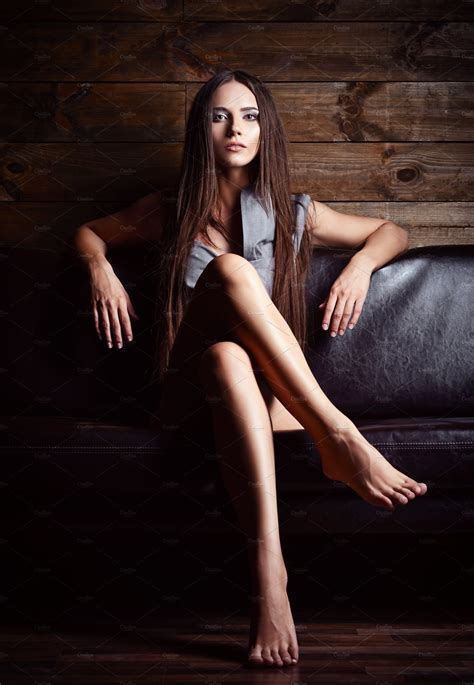 Beautiful Young Girl Sitting On Sofa High Quality People Images