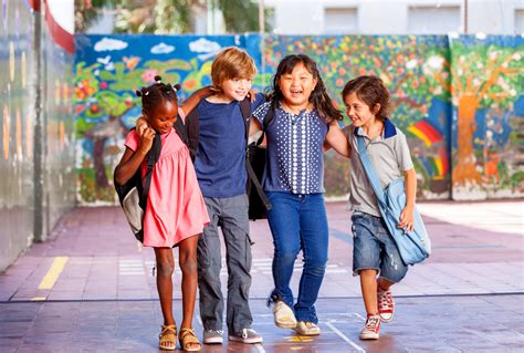 Schoolchildren Embracing Happy Multi Cultural Racial Classroom
