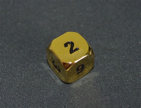 Gold Metallic D6 Six Sided Dice On Foam Surface In Bright Sunshine