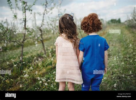 Little Boy And Girl In Blooming Garden Stock Photo Alamy