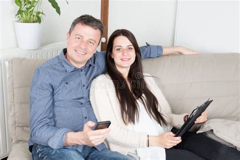 Father And Daughter Teen Using Tablet Smartphone On Sofa Stock Image