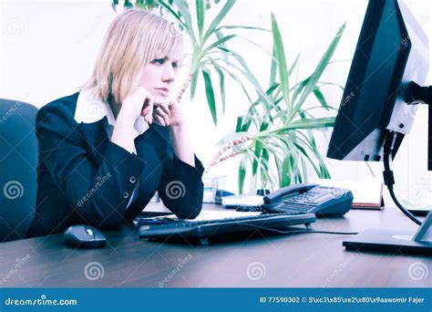 Blonde Businesswoman Working On Computer At The Office Stock Photo