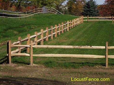 A general view of a back garden lawn with grey wood fences of a home. Split Rail Fence Black Locust Post - Rail Fence Paddock Fence