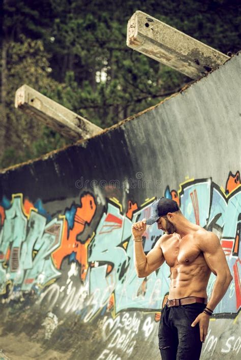 handsome man posing in front of graffiti wall editorial image image of healthy model 69797560