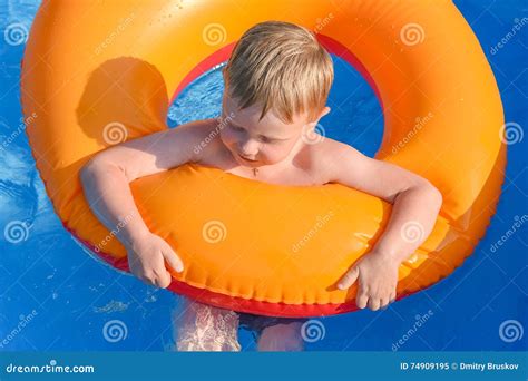Little Boy On An Inflatable Circle In The Water Stock Image Image Of