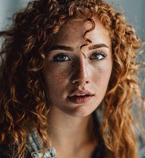 A Woman With Freckled Hair And Blue Eyes