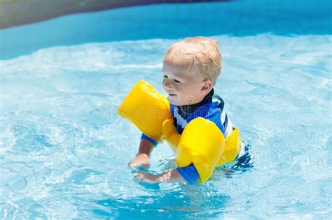 Baby With Inflatable Armbands In Swimming Pool Stock Image Image Of