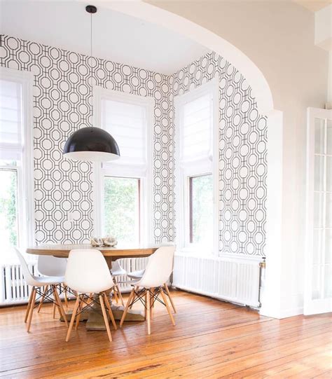 Monochromatic And Mid Century Modern Dining Room With Geometric Wallpap