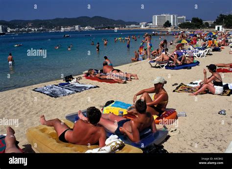 Holidaymakers Sunbathing On The Beach In San Antonio Ibiza Spain Stock Photo Alamy
