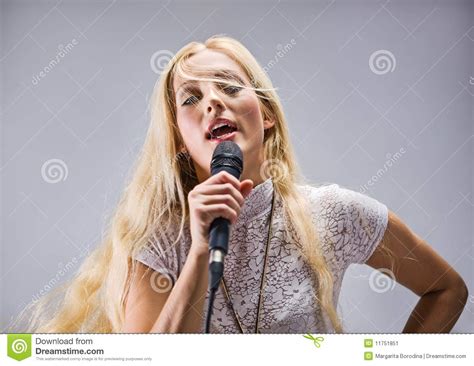 Woman Singing Into A Microphone Stock Image - Image: 11751851