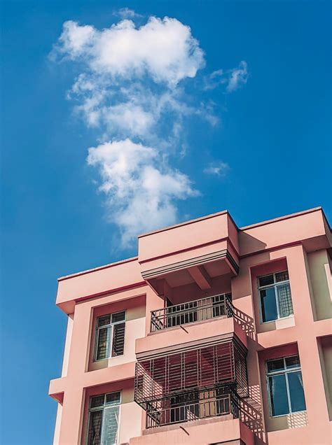 Pink And White Concrete Building Under Blue Sky During Daytime Photo