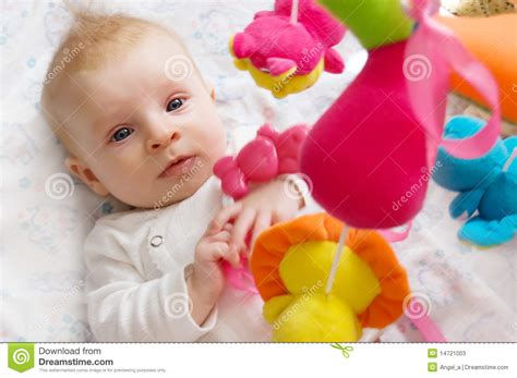 The constant input combined with some deep pressure can offer a sense of. Baby Girl Playing With Toys Stock Photos - Image: 14721003