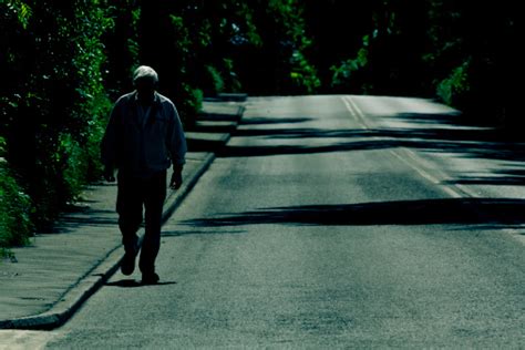Solitude Old Man Walking Alone On An Empty Road Stock Photo Download
