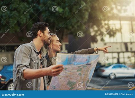 Let Curiosity Lead The Way Shot Of A Young Couple Using A Map While