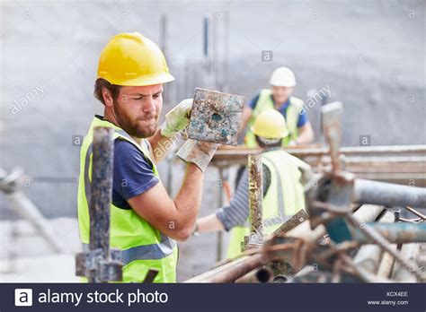 Any log, any plank, coal, or candy canes. Construction worker carrying metal bar at construction ...