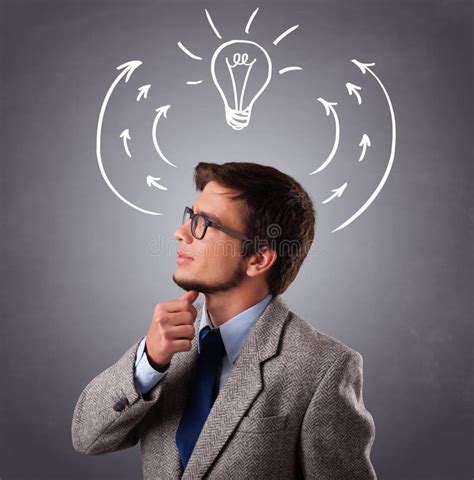 Young Man Thinking With Arrows And Light Bulb Overhead Stock Photo