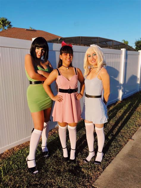 three women dressed in costumes posing for the camera