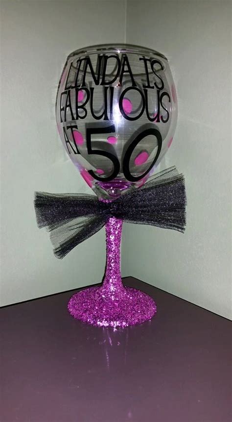 A Wine Glass With The Words Fabulous 50 On It And A Bow At The Bottom