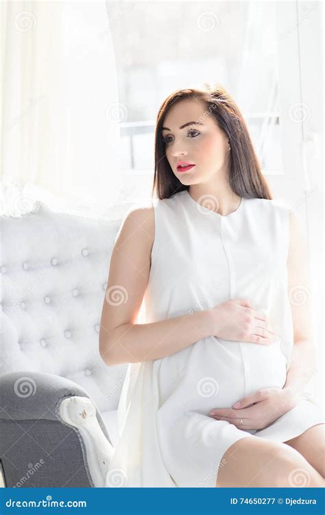 Beautiful Young Brunette Pregnant Woman In White Dress Stock Image