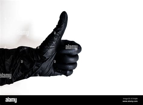 hand wearing black glove showing thumbs up gesture isolated on white self protection at home
