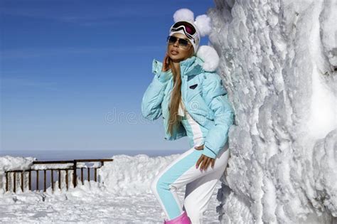 Beautiful Shapely Female Model Is Wearing Winter Clothing And Winter Hat And Colorful Boots And