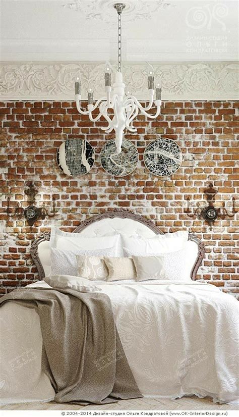 A Bedroom With A Brick Wall And Chandelier