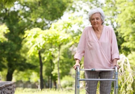Elderly Woman With Walking Frame Outdoors Stock Photo Image Of